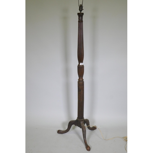 1089 - An antique mahogany standard lamp with carved reeded column and tripod supports, 145cm high