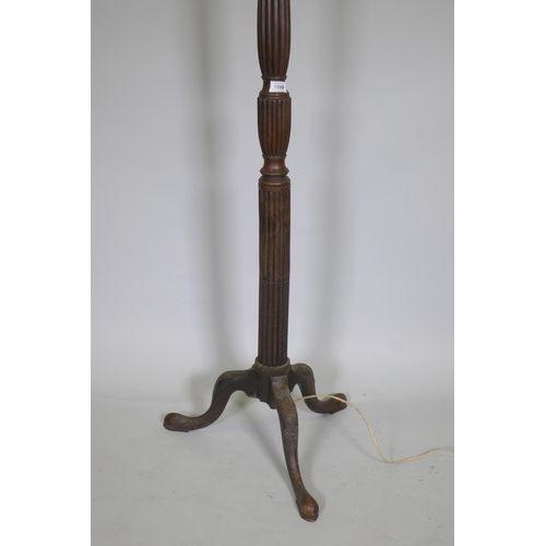 1089 - An antique mahogany standard lamp with carved reeded column and tripod supports, 145cm high