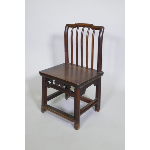 1091 - An antique Chinese elm spindle back low chair, 72cm high