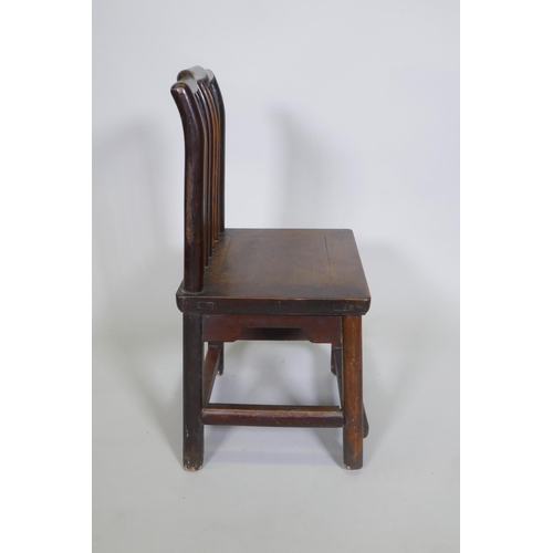 1091 - An antique Chinese elm spindle back low chair, 72cm high