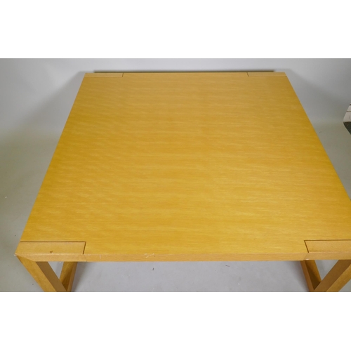 1095 - A contemporary blond oak coffee table, raised on square end supports, 120 x 120 x 48cm