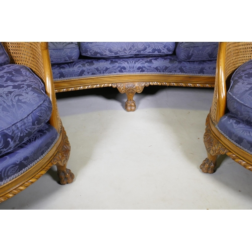 1099 - An antique walnut bergere suite comprising two chairs and settee, well upholstered, with carved shel... 