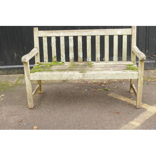 1109 - A weathered teak garden bench