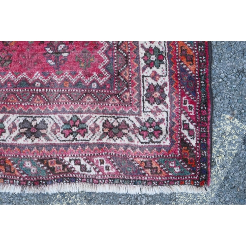 1116 - A Persian washed red ground full pile Qashqai tribal carpet, 216 x 294cm