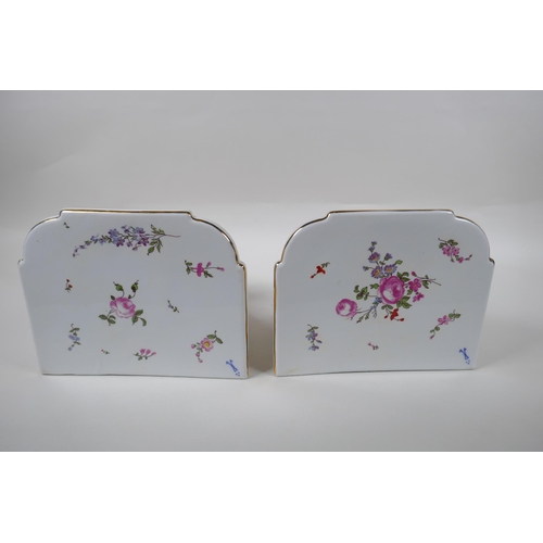 112 - A pair of Dresden style porcelain wall brackets decorated with putti and flowers, 24cm high