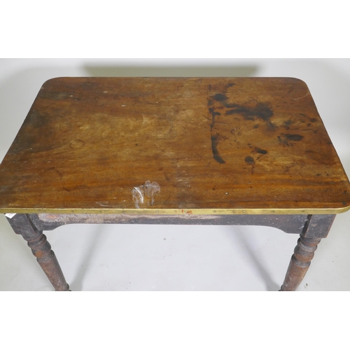 1125 - A C19th mahogany tavern type table, the one piece top with brass edge, raised on turned supports, 10... 