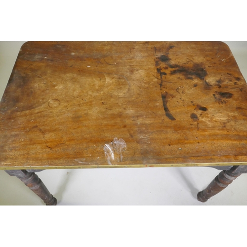 1125 - A C19th mahogany tavern type table, the one piece top with brass edge, raised on turned supports, 10... 