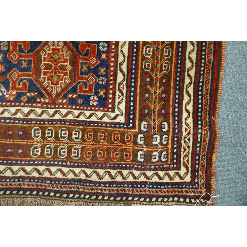 1127 - A Persian red ground wool Ghashghai carpet with unique medallion design, 172 x 260cm