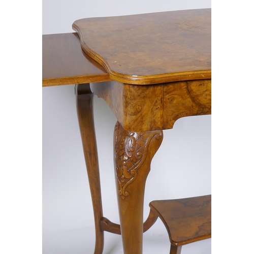 1128 - A burr walnut centre table, with shaped top and pull out slides, raised on carved cabriole supports ... 