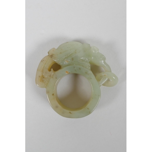 113 - A Chinese Nephrite archers thumb ring with carved mythical creature decoration