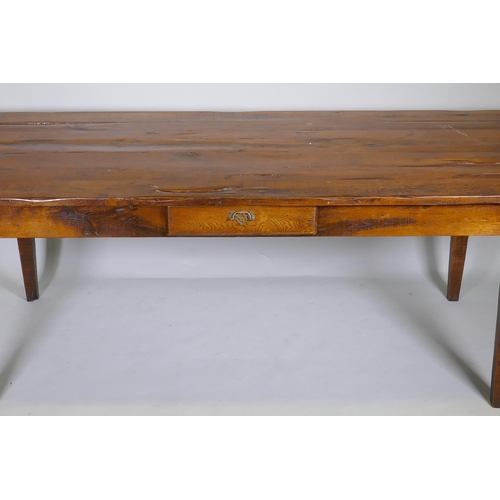 1136 - A French style oak farmhouse table with single drawer and cleated plank top, raised on square taperi... 