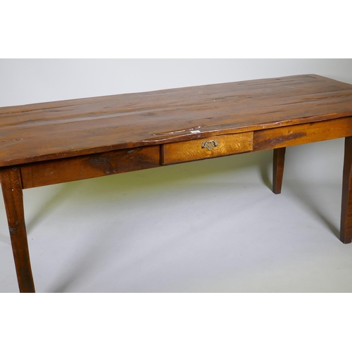 1136 - A French style oak farmhouse table with single drawer and cleated plank top, raised on square taperi... 