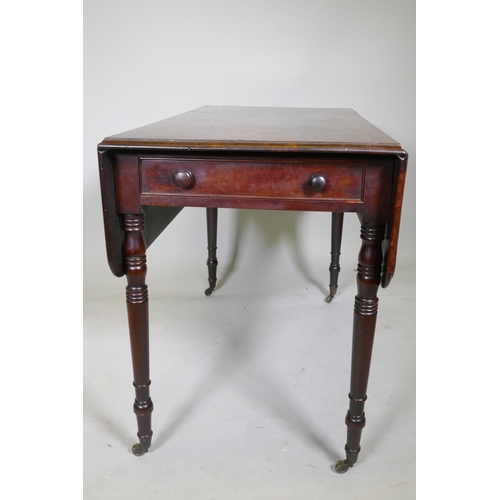 1141 - A Georgian drop leaf Pembroke table, with single end drawer, raised on ring turned tapering supports... 