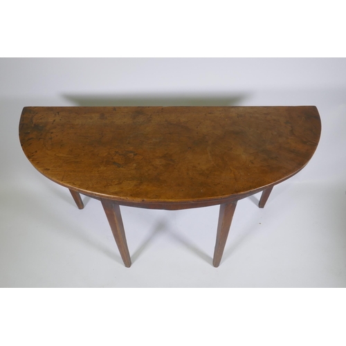 1146 - A C19th mahogany demi lune side table on square tapering supports, 122 x 46cm, 72cm high