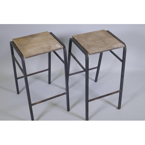 1171 - A pair of vintage industrial laboratory stools, with steel frames and ply seats, 52cm high