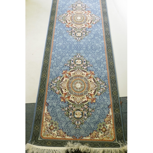 1190 - An Iranian fine woven blue ground runner with a medallion design and darker blue border, 80 x 310cm