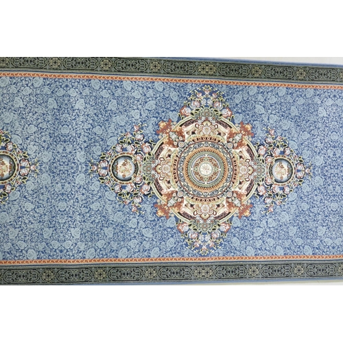 1190 - An Iranian fine woven blue ground runner with a medallion design and darker blue border, 80 x 310cm