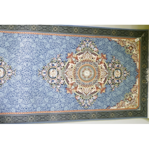 1190 - An Iranian fine woven blue ground runner with a medallion design and darker blue border, 80 x 310cm