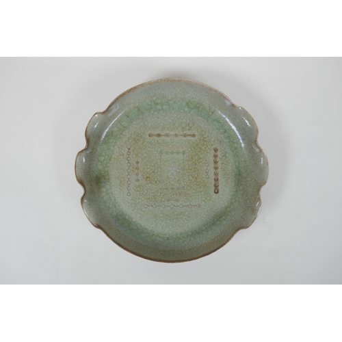 123 - A Chinese celadon crackle glazed porcelain dish with frilled rim, chased character inscription to ba... 