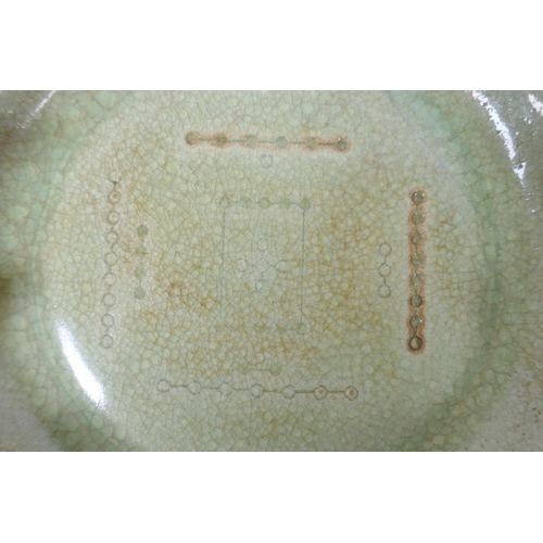 123 - A Chinese celadon crackle glazed porcelain dish with frilled rim, chased character inscription to ba... 