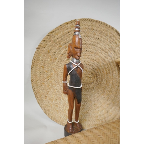 124 - A quantity of Kenyan tribal items to include carved wood head rests, gourd flask, woven baskets etc