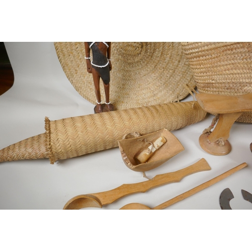 124 - A quantity of Kenyan tribal items to include carved wood head rests, gourd flask, woven baskets etc