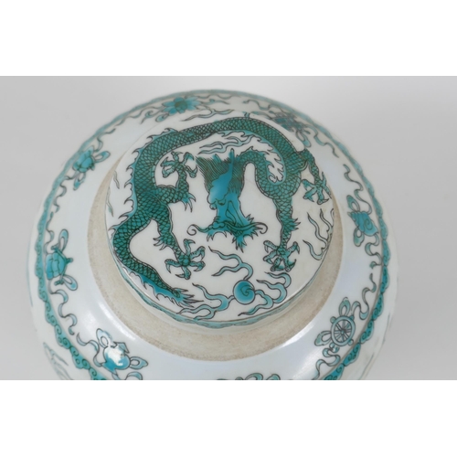 128 - A Chinese porcelain ginger jar and cover, decorated with emerald green dragons, chasing the flaming ... 