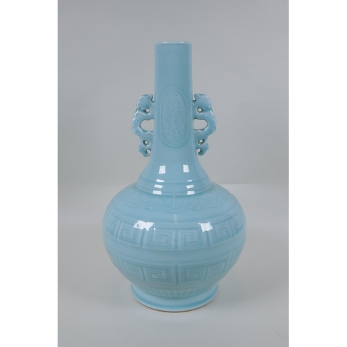 130 - A Chinese celadon glazed porcelain bottle vase with two handles and underglaze archaic style decorat... 