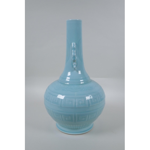 130 - A Chinese celadon glazed porcelain bottle vase with two handles and underglaze archaic style decorat... 