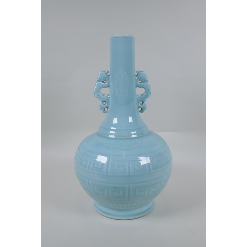 130 - A Chinese celadon glazed porcelain bottle vase with two handles and underglaze archaic style decorat... 