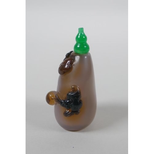 133 - A Chinese agate snuff bottle with carved kylin and ruyi decoration, 6cm high