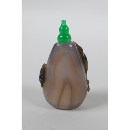 133 - A Chinese agate snuff bottle with carved kylin and ruyi decoration, 6cm high