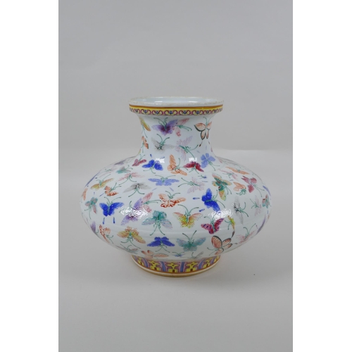 135 - A Chinese polychrome porcelain vase of squat form with all over butterfly decoration, GuangXu 6 char... 