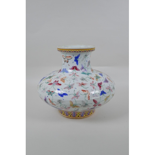 135 - A Chinese polychrome porcelain vase of squat form with all over butterfly decoration, GuangXu 6 char... 