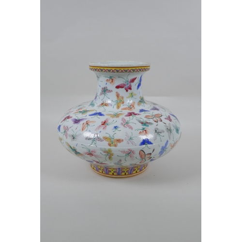 135 - A Chinese polychrome porcelain vase of squat form with all over butterfly decoration, GuangXu 6 char... 