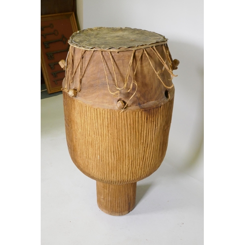 136 - An African Ashanti tribe Atumpan talking drum, 87cm high, 46cm diameter