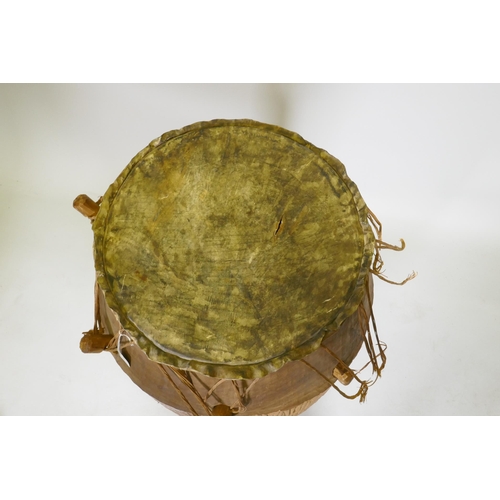 136 - An African Ashanti tribe Atumpan talking drum, 87cm high, 46cm diameter