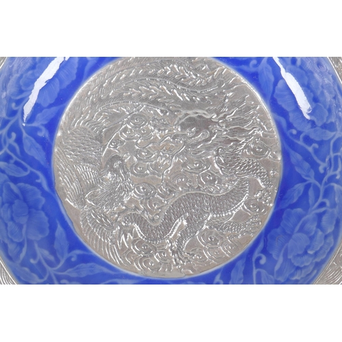 138 - A Chinese blue glazed porcelain bowl with silvered lobe rim and centre, with under glaze dragon, pho... 