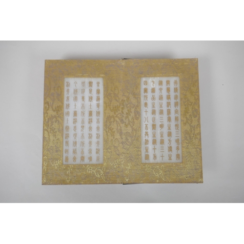 140 - A Chinese wood and silk bound book containing white jade tablet pages with chased and gilt inscripti... 