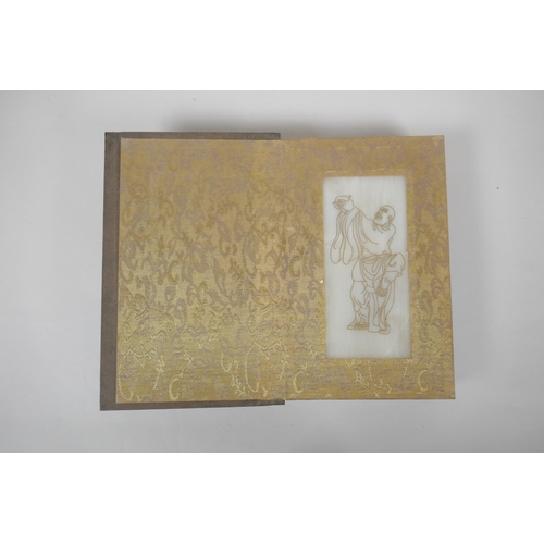 140 - A Chinese wood and silk bound book containing white jade tablet pages with chased and gilt inscripti... 