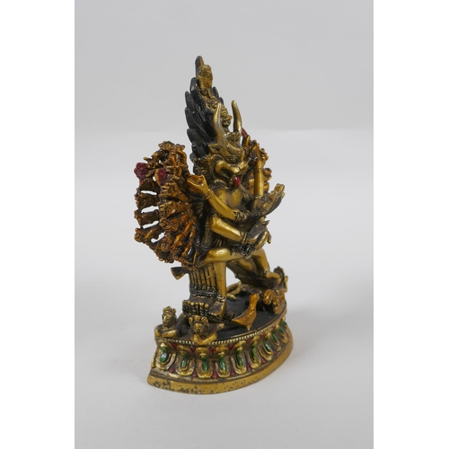 145 - A Tibetan gilt bronze figure of Yamantaka, with cold painted details, 18cm high