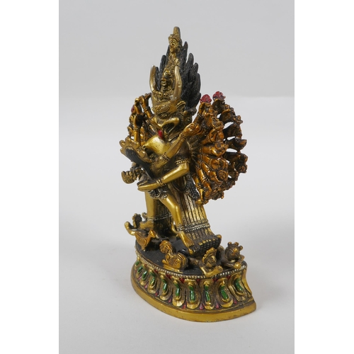 145 - A Tibetan gilt bronze figure of Yamantaka, with cold painted details, 18cm high