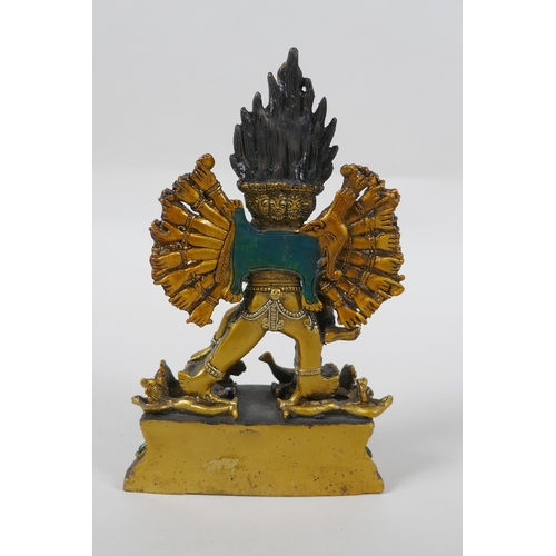 145 - A Tibetan gilt bronze figure of Yamantaka, with cold painted details, 18cm high