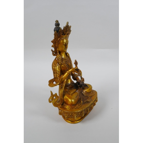 146 - A Tibetan gilt bronze figure of Vajrasuttra, double vajra mark to base, 20cm high