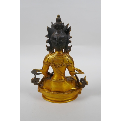 146 - A Tibetan gilt bronze figure of Vajrasuttra, double vajra mark to base, 20cm high