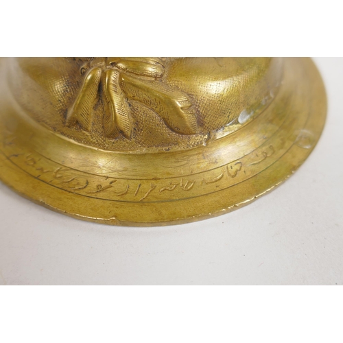 154 - An unusual brass candlestick with Arabic inscription to the base and raised insect decoration, 16cm ... 