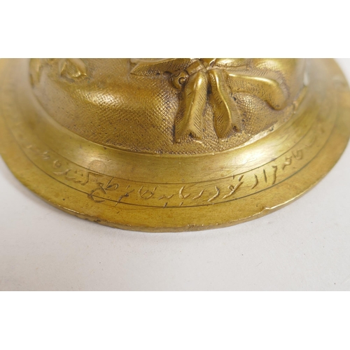 154 - An unusual brass candlestick with Arabic inscription to the base and raised insect decoration, 16cm ... 