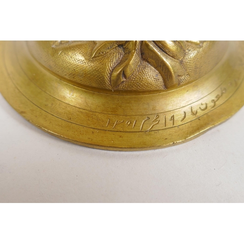 154 - An unusual brass candlestick with Arabic inscription to the base and raised insect decoration, 16cm ... 