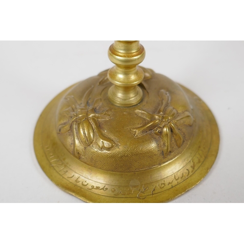 154 - An unusual brass candlestick with Arabic inscription to the base and raised insect decoration, 16cm ... 