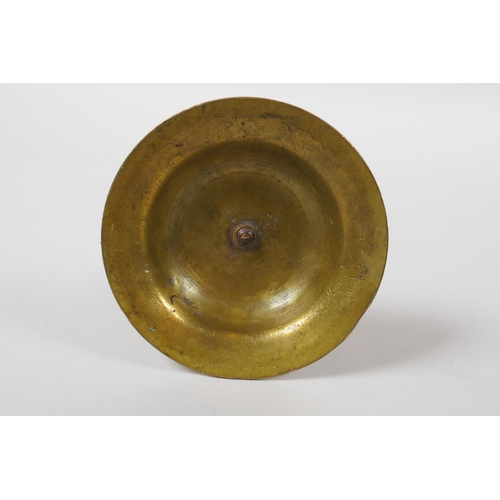 154 - An unusual brass candlestick with Arabic inscription to the base and raised insect decoration, 16cm ... 